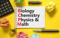 BCPM biology chemistry physics math symbol. Concept words BCPM biology chemistry physics math on white note on beautiful yellow Royalty Free Stock Photo