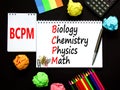 BCPM biology chemistry physics math symbol. Concept words BCPM biology chemistry physics math on the note on beautiful black Royalty Free Stock Photo