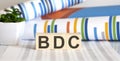 BDC written on a wooden cube in front of a charts Royalty Free Stock Photo