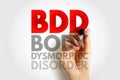 BDD Body Dysmorphic Disorder text concept. Red acronym with gray explanation below, drawn by a hand with a marker, symbolizing Royalty Free Stock Photo