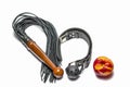 bdsm leather black gag whip and ripe peach fruit on white background Royalty Free Stock Photo