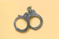 Bdsm and sex games concept. Handcuffs on beige background Royalty Free Stock Photo