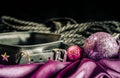 bdsm still life leather collar shibari rope and christmas ball on pink cloth close up
