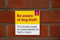 `Be aware of dog theft` sign outside of a supermarket informing the public they arent responsible for any harm or thefts that ma