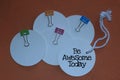 Be awesome today. Concept with positive note on white tag label papers and colorful smiling clips stationary