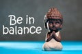 Be in Balance - motivation for balancing between life, work, family, sport and yoga. Meditating babby Buddha Royalty Free Stock Photo