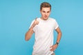 Be careful, I`m warning you! Portrait of young serious man in t-shirt standing with admonishing gesture Royalty Free Stock Photo