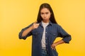 Be careful! Portrait of serious displeased girl in denim shirt pointing finger to camera, warning of mistake