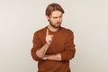 Be careful! Portrait of strict teacher, bossy man with beard wearing sweatshirt standing with admonishing gesture Royalty Free Stock Photo