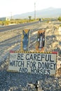 Be Careful of wild donkey and horses road sign along side highway Pahrump, Nevada, USA Royalty Free Stock Photo