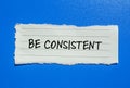 Be consistent words written on torn paper with blue background