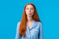 Be funny and silly. Redhead carefree and enthusiastic caucasian girl squinting, making goofy expression, showing tongue