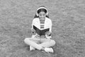 be a good achiever. knowledge day. future school education. teen girl with book on green grass. pretty child little girl