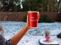 Be happy - inscription on a red mug held in a woman`s hand