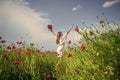 Be happy. summer vacation and holiday. pretty woman in white dress walking in poppy field. bride in meadow. romantic Royalty Free Stock Photo