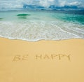 Be happy written in a sand
