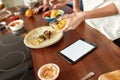 Be healthier. Close up of process of cooking. Woman preparing healthy meal in the kitchen checking recipe using tablet Royalty Free Stock Photo