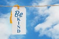 Be Kind message white gift tag over sky Royalty Free Stock Photo