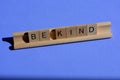 Be Kind in wooden alphabet tiles on a wood rack