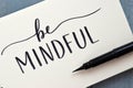 BE MINDFUL hand-lettered in notepad with brush pen Royalty Free Stock Photo