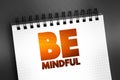 Be Mindful text on notepad, concept background