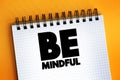 Be Mindful text quote on notepad, concept background