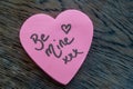 Be Mine hand wrote text on pink love heart with drawn hearts. On rustic wooden background. Love Valentines concept