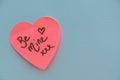 Be Mine hand wrote text on pink love heart with drawn hearts. On white isolated background. Love Valentines concept