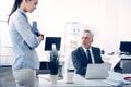 Dissatisfied box giving young female employee lecture Royalty Free Stock Photo