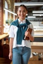 Be multitasker. Confident asian female office worker posing indoors
