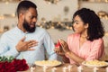 Black woman making proposal with ring to her surprised boyfriend Royalty Free Stock Photo