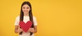 be my valentine. teen girl on yellow background. love present with copy space. Kid girl portrait with heart love symbol