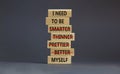 Be myself symbol. Businessman hand. Wooden blocks with words `i need to be myself, not smarter, thinner, prettier, better`.