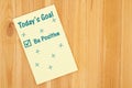 Be positive goal message on a yellow legal lined notepad paper Royalty Free Stock Photo