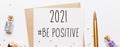 2021 be positive note with envelope gifts and gold glitter stars on white background. merry christmas and New Year concept