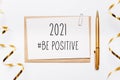 2021 be positive note with envelope pen gifts and gold ribbon on white background. merry christmas and New Year concept