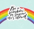 Be a rainbow in someone else`s cloud. Positive inspiration quote with rainbow at blue sky background