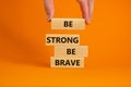 Be strong be brave symbol. Wooden blocks with words \'be strong be brave\'.