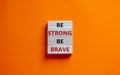 Be strong be brave symbol. Wooden blocks with words \'be strong be brave\'.