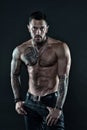 Be strong. muscular bodybuilder with body tattoo. athletic male show abdominal muscles. fitness model topless