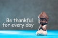 Be Thankful for every day - inspirational and motivating text near little buddha figurine