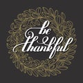 Be thankful handwritten lettering inscription on golden laurel w