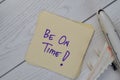 Be On Time write on sticky notes isolated on Wooden Table