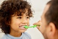 Be true to your teeth and they wont be false to you. a father teaching his son how to brush teeth at home. Royalty Free Stock Photo