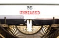 Be unbiased symbol. Concept words Be unbiased typed on white paper on old retro typewriter. Beautiful white background. Business Royalty Free Stock Photo