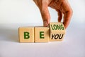 Be you belong symbol. Businessman changes words 'be you' to 'belong'.