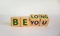 Be you, belong symbol. Turned cubes and changed words `be you` to `belong`. Beautiful white background. Business, belonging an