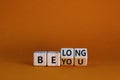 Be you, belong symbol. Turned cubes and changed words `be you` to `belong`. Beautiful orange background. Business, belonging a