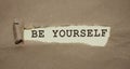 Be yourself phrase written under torn paper. Personal brand rebranding concept