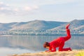 BeaBeautiful mature woman doing gymnastics on a sandy beach on a backgroundnastics on a sandy beach on a background